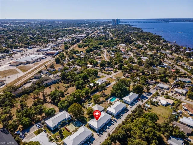 Aerial perspective of suburban area featuring a nearby body of water