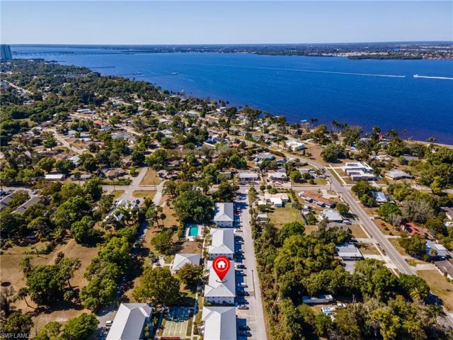 Aerial view of residential area featuring a large body of water