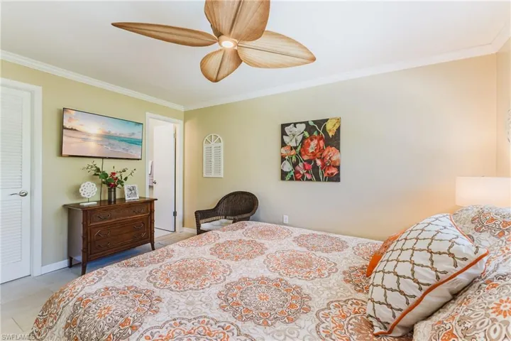 Bedroom with crown molding and ceiling fan