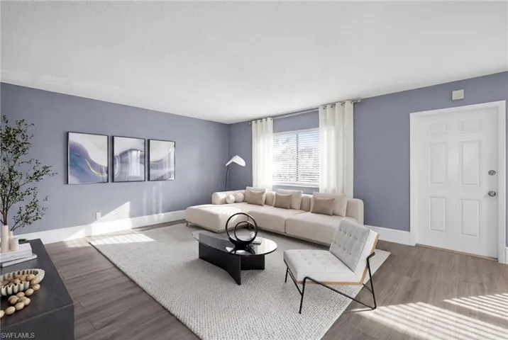 Living area with wood finished floors and baseboards