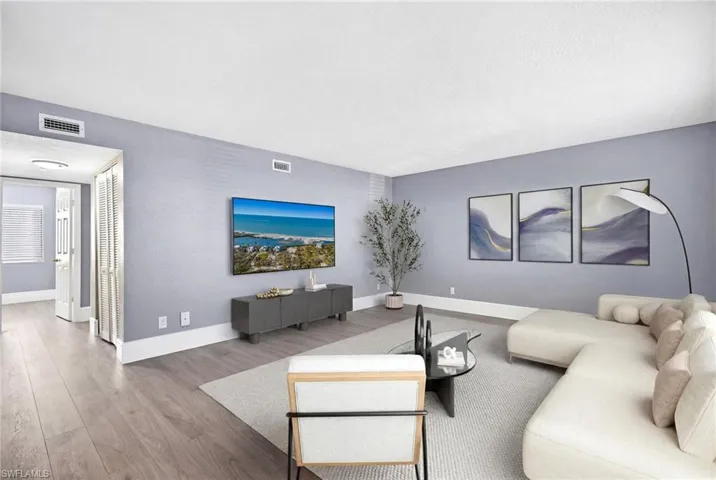 Living room with light wood-style floors and baseboards