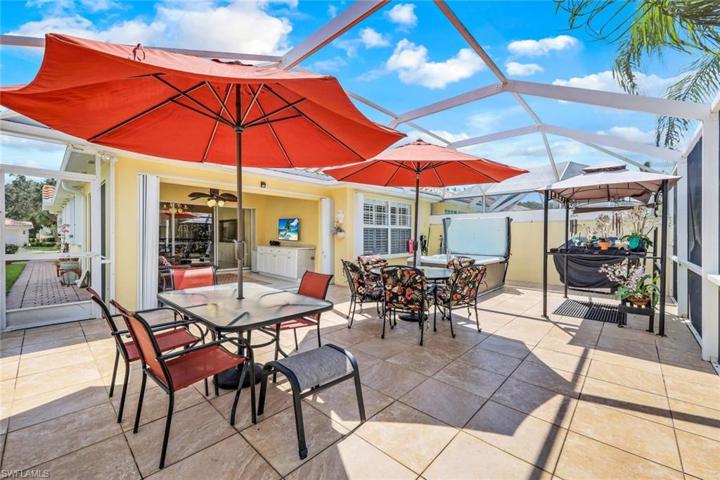 Extended lanai with tile, covered area, pergola and hot tub.