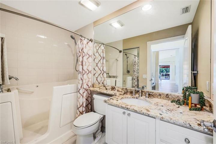 Guest bathroom with granite counter tops and custom shower/walk-in tub.