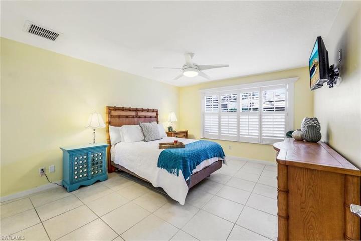 Primary bedroom with plantation shutters.