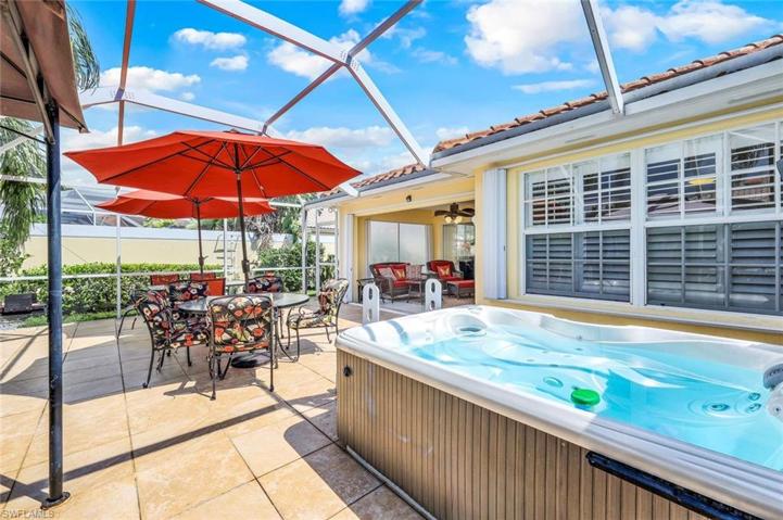Extended lanai with tile, covered area, pergola and hot tub.