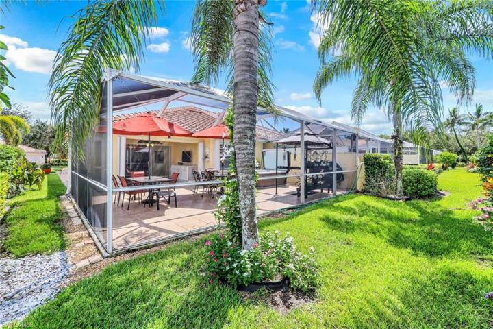 Rear of residence with extended lanai, hot tub and pergola.