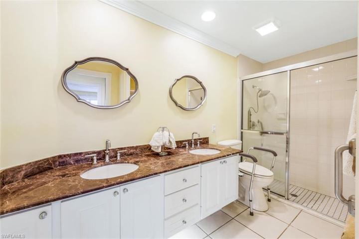 Primary bathroom with dual sinks, shower and makeup area.