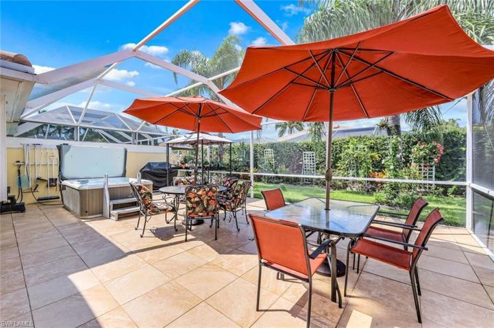 Extended lanai with tile, covered area, pergola and hot tub.