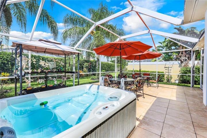 Extended lanai with tile, covered area, pergola and hot tub.
