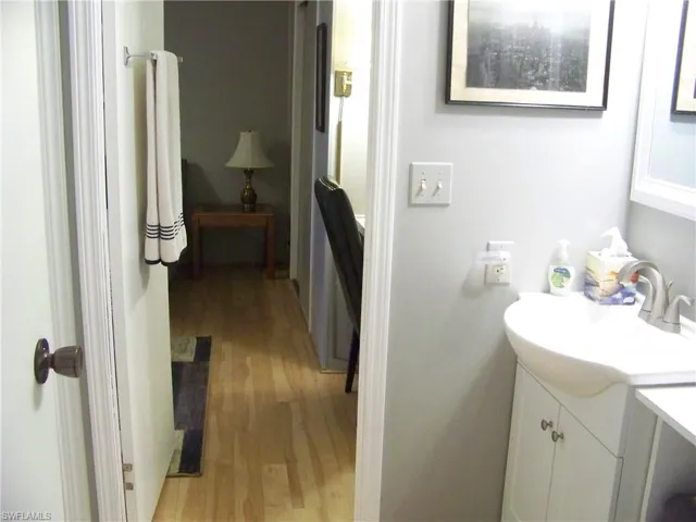 Guest bathroom has single sink, walk-in shower only. Door to guest room & door to hall.