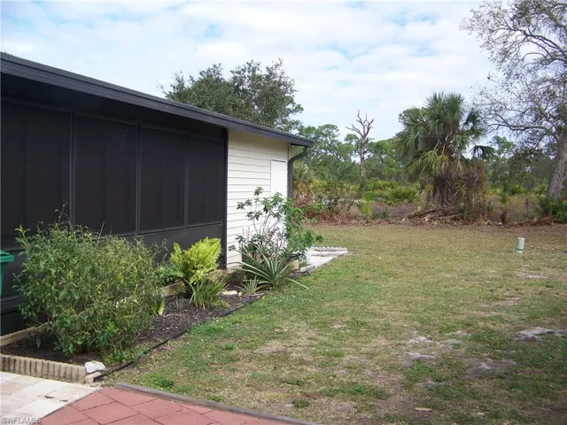 Right side of home, all weather lanai windows/side door to shed.