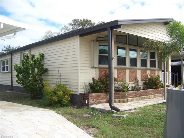 Left side of home and another view of front. Has accordion shutters all the way around.