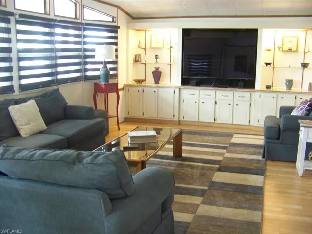 Living room w/built-ins and tons of windows/custom blinds