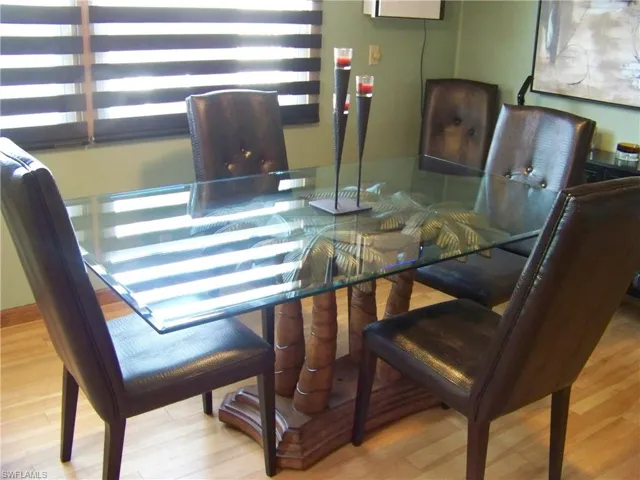 Dining room with great glass table/palm tree base and it comes with the sale!!!