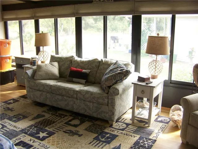 All weather lanai has custom honeycomb window treatments and plenty of room to entertain.