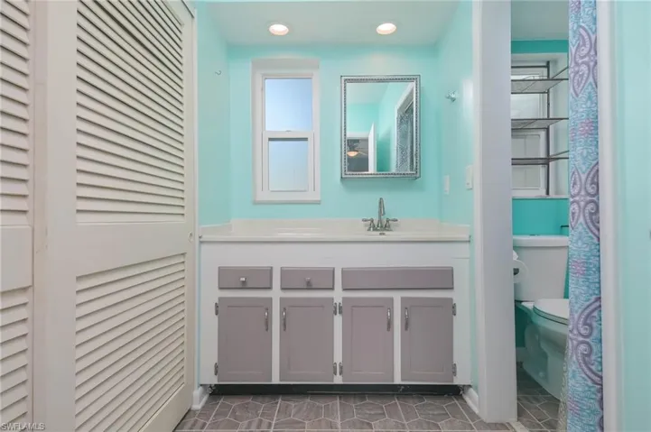 Bathroom with tile patterned flooring, vanity, and toilet