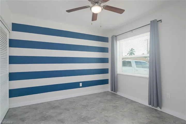 Empty room featuring ceiling fan