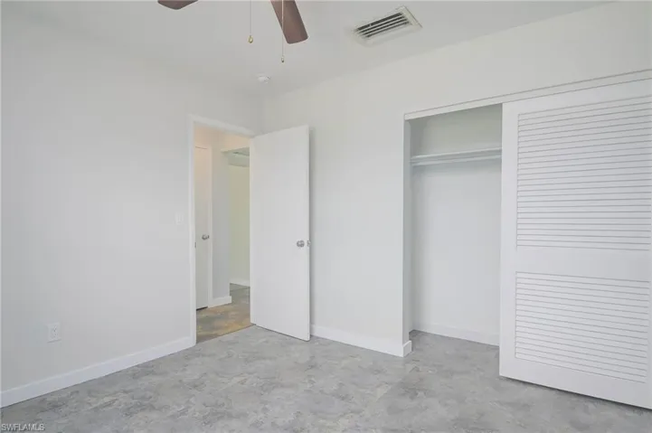 Unfurnished bedroom featuring ceiling fan and a closet
