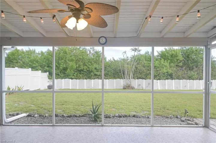 Unfurnished sunroom with wooden ceiling, track lighting, beam ceiling, and ceiling fan