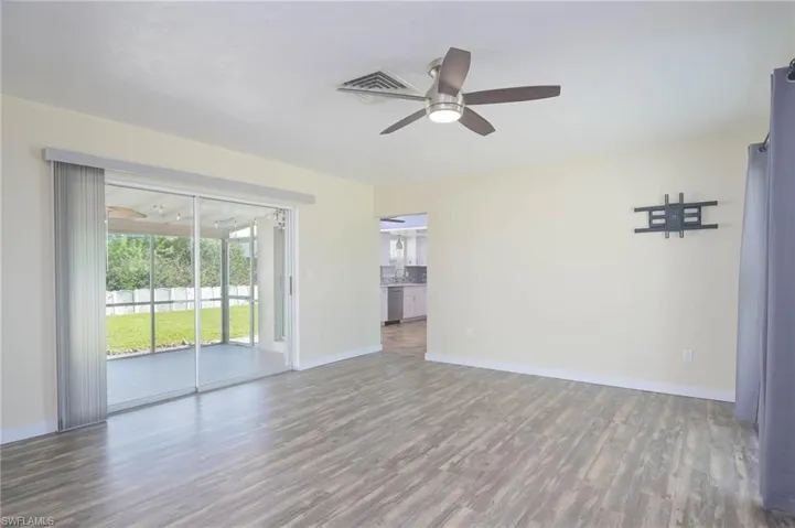 Unfurnished room featuring ceiling fan and hardwood / wood-style flooring