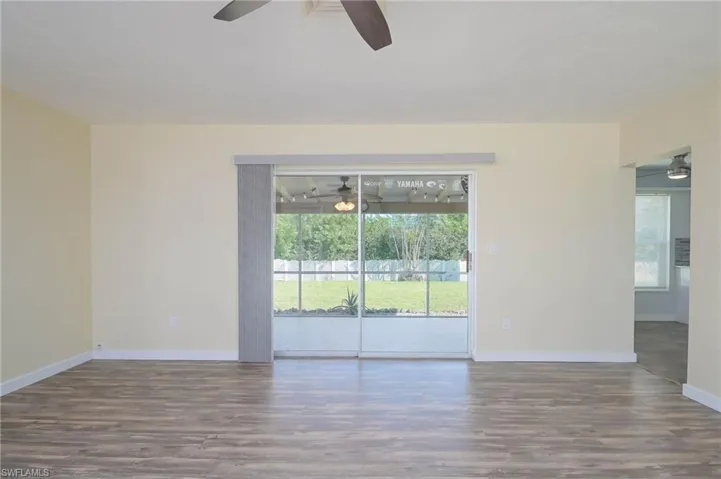 Unfurnished room featuring ceiling fan and hardwood / wood-style flooring