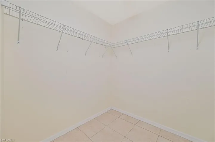 Spacious closet with light tile patterned flooring