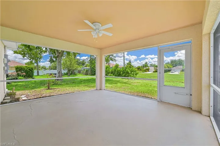 Unfurnished sunroom featuring ceiling fan