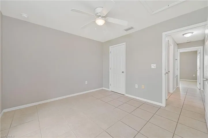 Unfurnished room featuring a ceiling fan and light tile patterned floors
