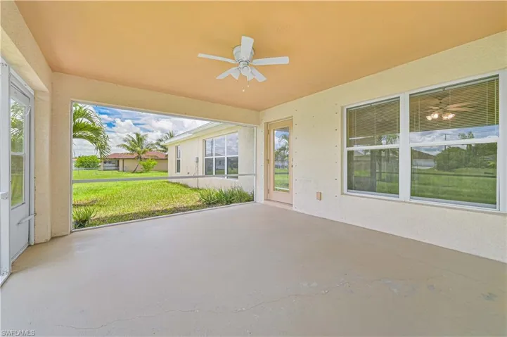 Unfurnished sunroom featuring ceiling fan