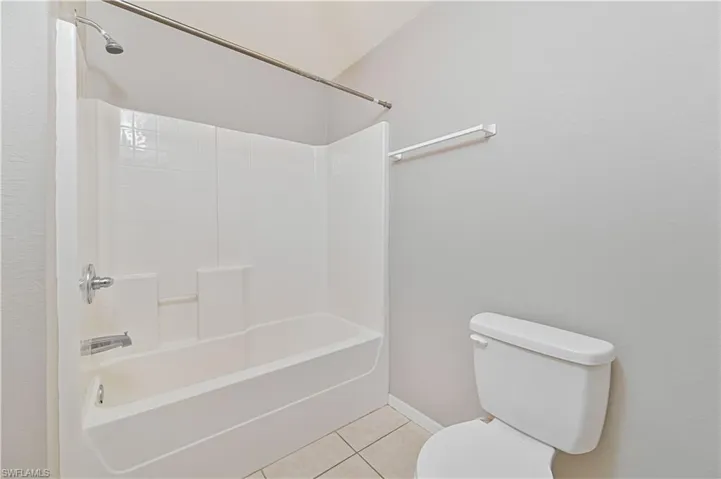 Full bath featuring tile patterned flooring and shower / tub combination