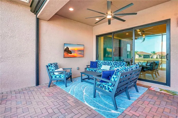 View of patio featuring an outdoor hangout area and a ceiling fan