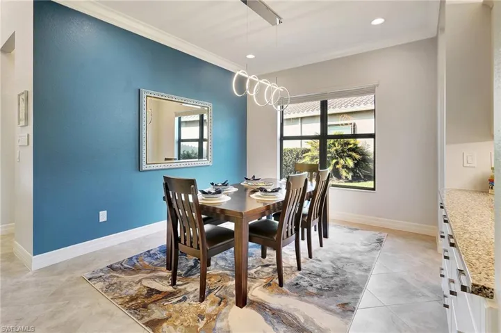 Dining area featuring crown molding, recessed lighting, and light tile patterned floors