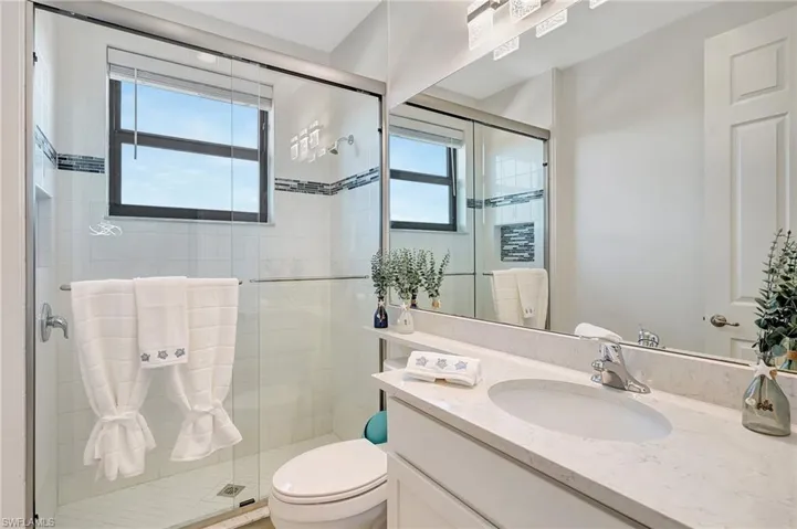 Bathroom featuring vanity and a stall shower