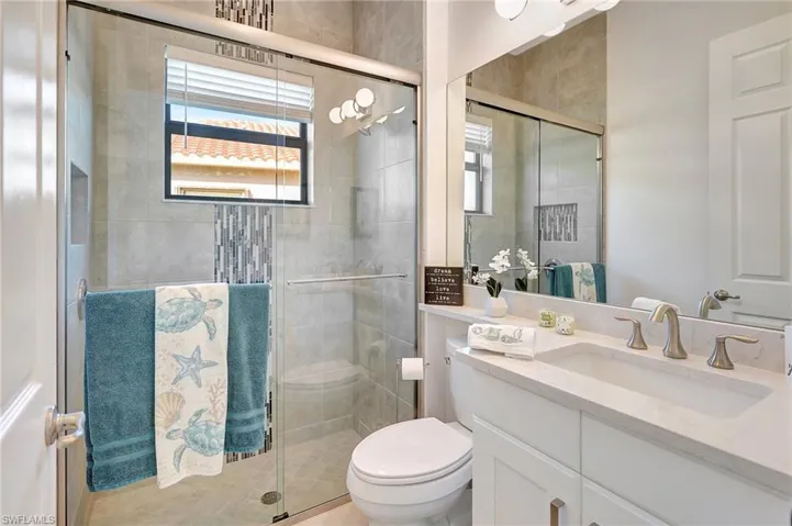 Full bath with vanity and a stall shower