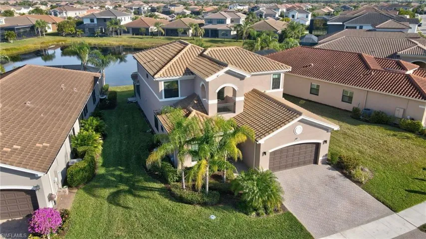 Aerial perspective of suburban area featuring a large body of water