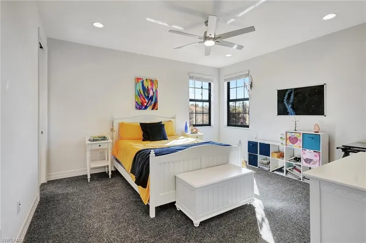 Bedroom featuring dark colored carpet, recessed lighting, and a ceiling fan