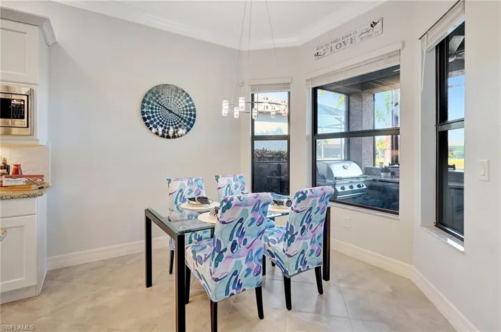 Dining area featuring crown molding and light tile patterned flooring