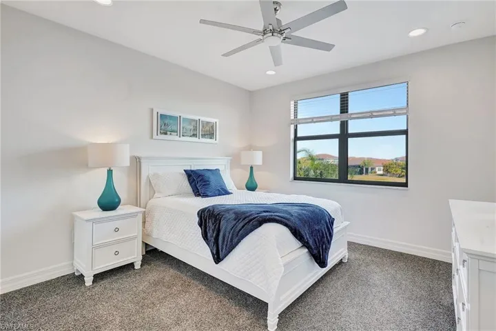 Carpeted bedroom featuring recessed lighting and a ceiling fan