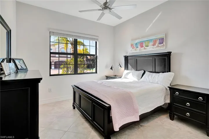 Bedroom featuring light tile patterned flooring and ceiling fan
