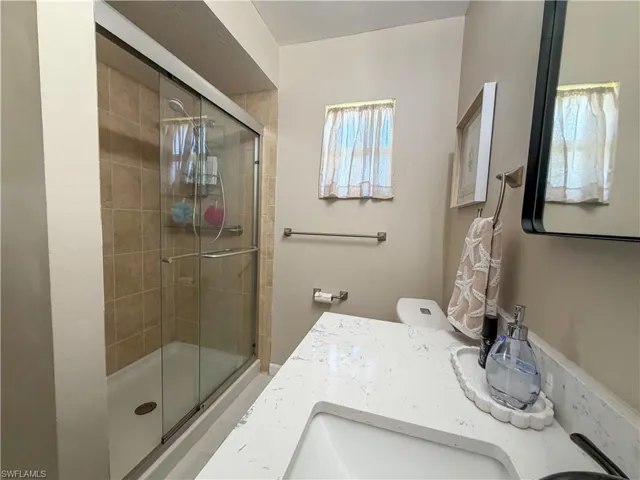 Full bathroom featuring vanity and a stall shower