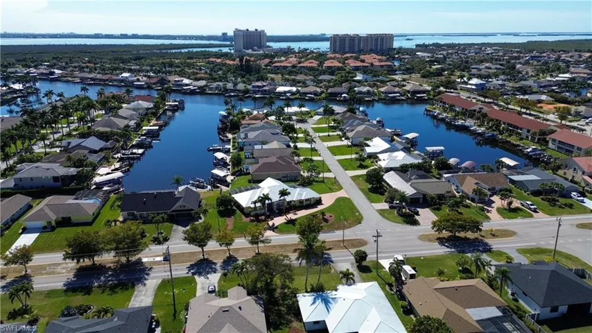 Aerial view of property's location with nearby suburban area and a nearby body of water