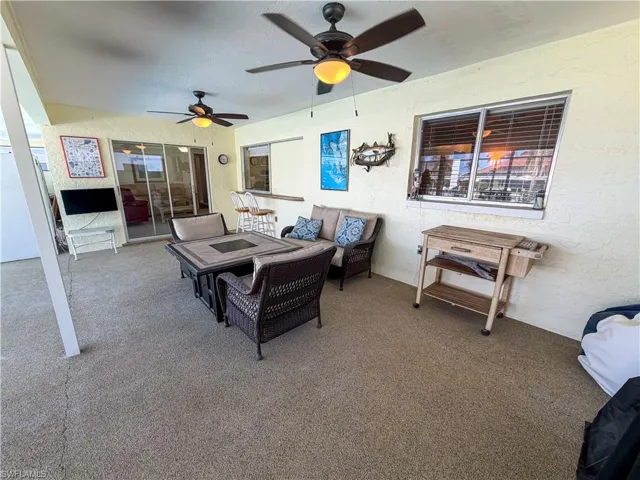 View of patio with an outdoor lounge area and a ceiling fan