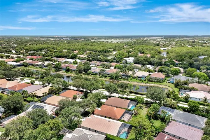Residential community with mature tree canopy and multiple water features