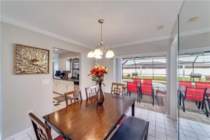 Dining room with open sliders to pool