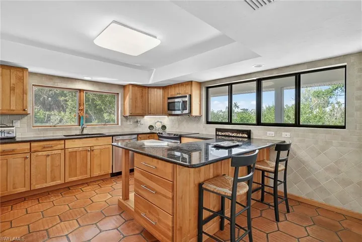 Treetop views, warm tile floors, and a kitchen made for connection