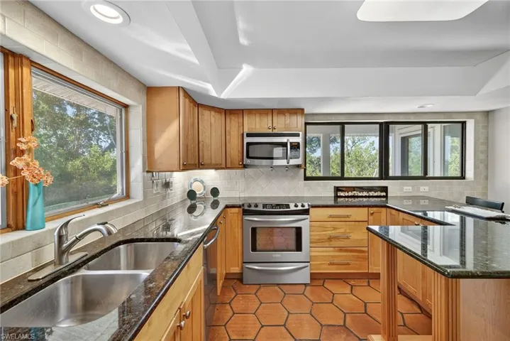 Bright, open, and surrounded by nature this thoughtfully designed kitchen perfect for family moments