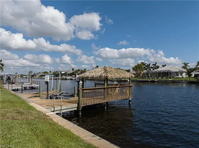 Dock area with boat lift and a water view