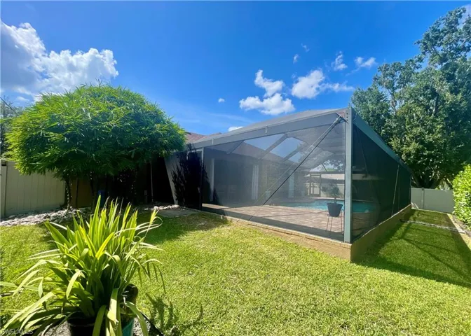 View of pool enclosure featuring a fenced backyard and a pool,