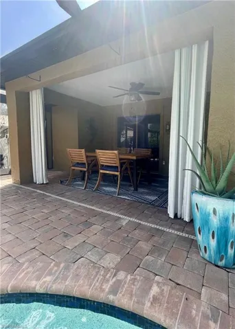 View of patio featuring outdoor dining area and a ceiling fan