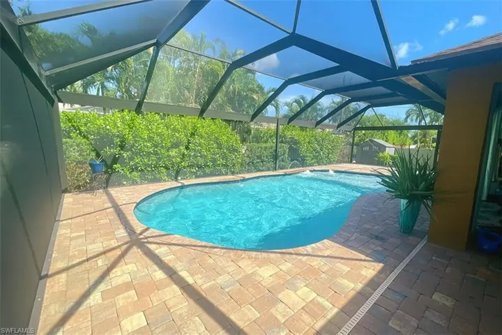 Swimming pool with a patio area and a lanai